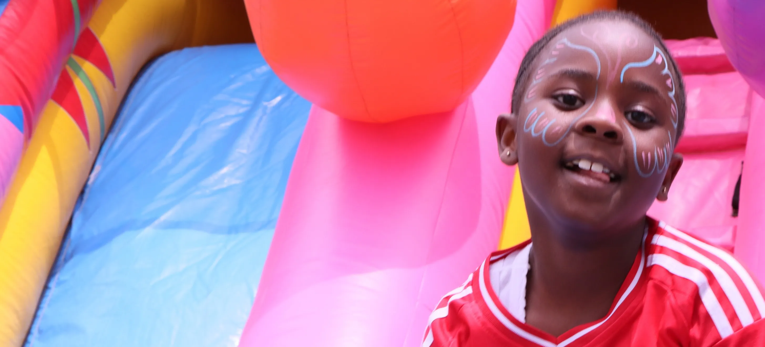 Children playing at a colorful bouncy castle